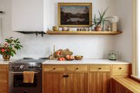 The second floor of this historic brick building was originally divided into two small rental apartments. The project involved creating a new large kitchen, living room and dining room. When construction began, the original wide plank heart pine floors were uncovered. The kitchen millwork, with nickel gap detailing, was finished to reflect the character of the wood.