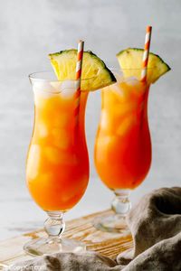 TGI Friday’s Island Rum Punch is a tasty tropical cocktail perfect for hot summer days and fun occasions. Get the easy copycat recipe and find out how to make the best rum punch with Captain Morgan spiced rum, dark rum, amaretto, fruit juices, and grenadine. If you enjoy a Caribbean or Jamaican rum punch, you will love this fruity drink! #rumpunch #cocktailrecipe #tgifridays #copycat #copycatrecipe