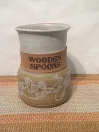 1980s style earthenware ceramic Wooden Spoon holder. Great condition. Glazed in attractive earth tones, this nostalgic pottery piece would be fun in any kitchen! Measures 7 tall X 5 wide.