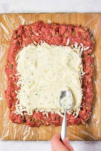 Mozzarella Stuffed Meatloaf - seasoned to perfection, stuffed with three kinds of cheese and topped with your favorite tomato sauce, this easy Lasagna Meatloaf will make you forget all about the noodles! It's a hearty family meal that'll have everyone reaching for more.