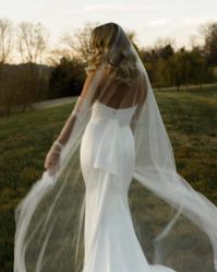 Made of barely-there soft tulle, the Paige ultra sheer wedding veil gives the most ethereal finish to a romantic bridal look. Designed with the modern bride in mind, this wedding veil is not gathered on the comb, so it flows down in a fine, transparent layer that lets every gown detail shine though. The dramatic wide train makes for beautiful bridal portraits and wedding ceremony moments. If you have questions about this wedding veil or would like some styling advice, then please don't hesitate