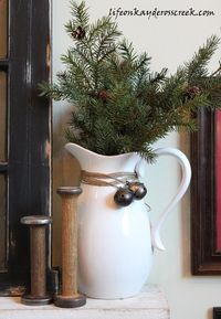 This Christmas home tour was so some much fun to do this year and inexpensive! I pulled the black, red and white color scheme from the pillow on the white chair which I made from a button down shirt.   I used lot of greens, which are readily available up in our area of the North East.   The tree is enormous!   I carried the same black, red and white theme throughout the kitchen but kept it simple.   Flea market finds and the 1-9 sign I made brighten up the counter...   It's in the litt…