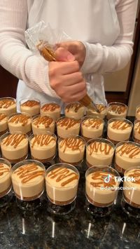 This recipe makes about 30 mini cheesecake cups (60mL cups). Bottom Biscoff crumble layer: Crumble 1 pack (250 g) of lotus Biscoff biscuits. Scoop 1 tbsp of crumbs into each cup and flatten them. Middle cheesecake layer: Whip 1 cup cream cheese and ¾ cup Lotus Biscoff spread in a bowl. In a separate bowl, add 1 ⅓ cup cold heavy cream, ½ cup powdered sugar, and 1 pack of vanilla sugar, then whip these together until stiff peaks form. Fold the whipped cream mixture into the cream cheese mixture. Pipe a thick layer of this cheesecake mixture into each cup. Top: Melt ¼ cup of Lotus Biscoff spread & drizzle some onto the top of each cheesecake cup. Crumble 2 Biscoff biscuits to decorate the cheesecake cup tops. Refrigerate & serve the cheesecake cups cold credits to: @daniascuisine