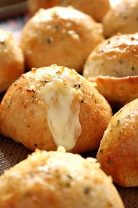 Easy Garlic Cheese Bombs Recipe - biscuit bombs filled with gooey mozzarella, brushed with garlic Ranch butter and baked into perfection. Easy, fast and absolutely addicting!