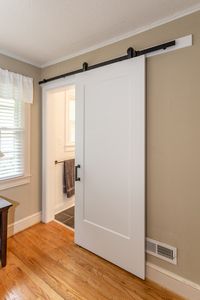 Sliding barn doors are a great way to make a statement without taking up too much precious floor space #sliding #barndoors #bathroom #custom #renovation #ideas #ashmorebuilders