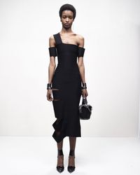 A slashed bandage dress in black compact knit. From the Alexander McQueen Autumn/Winter 2022 collection by Sarah Burton.