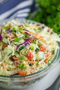 This Summer Slaw takes our family favorite southern coleslaw recipe and adds fresh summer vegetables, including cherry tomatoes, cucumbers, and green onions, and tosses it in a creamy, tangy dressing. Easy to make and a perfect summer side!