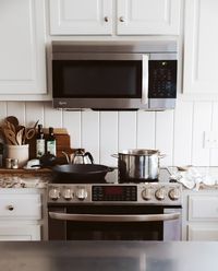 White Shiplap behind Sink and Stove - The Quick Journey