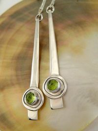 Ive been wanting to make some long, slim, modern earrings for some time and these fit perfectly. They are handcrafted from sterling silver and 5mm rose cut peridot cabochons set in fine silver bezels. I gave the stems of the earrings a lightly hammered texture and highly polished them