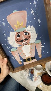 Painting a upcycled decor with a nutcracker.