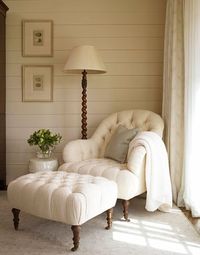 white tufted chair + ottoman, spindle light, white floors