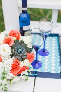 royal blue and coral wedding colors 2023, royal blue bridesmaid dress, coral wedding invitations, coral and white flower decorations in wedding cake, wedding table centerpieces, royal blue wedding plates, wedding table number card and wedding ring box. Check it and get more inspirations!