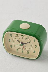 Bring vintage charm to your bedside tables with this retro-inspired alarm clock. This alarm clock features large, easy-to-read numbers and makes a traditional beeping sound that can easily be snoozed with a shut-off button at the top. Features Retro Alarm Clock Colorful plastic casing with an ivory face Large, easy-to-read numbers Traditional beeping alarm sound Shut-off button at the top to dismiss alarms Requires one AA battery - not included Perfect for gifting Content + Care ABS, clockworks Wipe clean Imported Size Dimensions: 4.25" l x 2.2" w x 3.5" h | Retro Alarm Clock in Green at Urban Outfitters