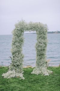 Baby's breath and mossy branch ceremony wedding arch