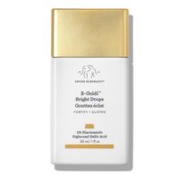 Illuminate the skin and add a golden finish with the Drunk Elephant B-Goldi Bright Drops, a barrier-strengthening serum that revives dull skin without being sparkly or glittery. Working to add clarity and radiance to the skin, this serum can be applied to the face, chest or legs. Infused with 5% niacinamide, mulberry leaf extract and diglucosyl gallic acid, this serum helps to fade hyperpigmentation, dark spots and post-breakout marks. Light-reflecting pigments work to give the skin a touch of luminosity, while replenishing omega oils nourish and smooth the skin. Designed to be mixed with Drunk Elephant’s moisturisers, serums and oils, Drunk Elephant B-Goldi Bright Drops add the prettiest hint of colour. This serum is suitable for use with all skin types. KEY BENEFITS 5% Niacinamide to imp