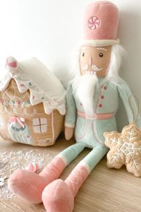 It's that time of year and Candy Nutcracker Doll is the perfect accent to any home at the holidays. Adorned is best selling rose pink and minty green, Candy Nutcracker is perfect for shelves and mantles. Introduce a young mind to the beloved fairy ballet set at the foot of a Christmas tree with Mon Ami’s Candy Nutcracker Plush Doll. Our Christmas plush doll will spark hours of play and nights of sweet dreaming in the countdown to Christmas. Although traditional nutcrackers are wooden and sturdy, our Nutcracker plush doll is a total softie with his plush body, silky white beard and pastel uniform—complete with a peppermint-adorned top hat.100% PolyesterPerfect for playing, snuggling for gift-givingSpot clean only and air dryMeasures 18 in / 45.75 cmSEASONAL ITEMS ARE FINAL SALE