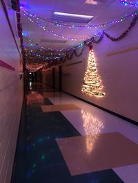 Colored lights, red and green paper chains, and a wall Christmas tree