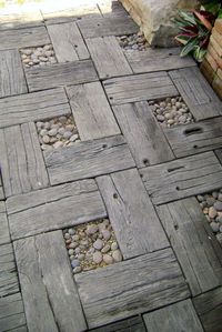 Concrete pavers. They only look like wood, but without the upkeep and rot!