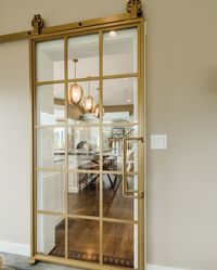 This French Barn Door provides a perfect sense of regularity, proportion and illumination. Borrowing from similar aesthetic and function, our French Barn Doors are made to allow natural light in, yet provide a solid barrier perfect for separating rooms or joining the inside of the home with outside views. This product is perfect for separating the dining room from the kitchen or as bi-parting office doors! ( #📷: @hmcollinsphotography @mandevillecanyondesignsnh )