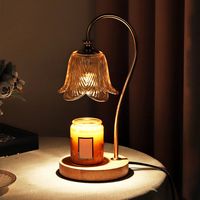 This is a table lamp that can emit fragrance, and the flower shaped glass lamp shade has a bulb inside, which can let out warm and bright light. Its working principle is to use the lamp bulb heating to accelerate the surface of the candle evenly heated melting, emitting pure aroma, and no open flame, more safe and environmentally friendly.   This bedside table lamp has two options: wooden base and marble base, which combines classic and modern design. It can be used in bedrooms, living rooms, st