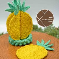 Bring a tropical vibe to your room by crocheting your own pineapple coasters. This pineapple slices coaster set can be a decorative and functional addition to your table, and when each coaster is folded in half and placed in the little container, the set looks like a bowl of pineapple halves, or a whole pineapple if placed straight up. This crochet pattern is a fun project for beginners to get comfortable with altering stitches in one round and have a fun taste of using bobble stitches in a croc