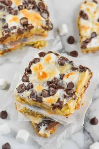 These S'mores Magic Bars will disappear almost as fast as you can make them, they are irresistible! Made up of absolutely amazing layers of graham cracker, sugar cookie, chocolate, marshmallows, and topped with sweetened condensed milk, there is a LOT to love about these!