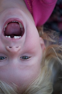 Missing tooth - girl with missing #tooth hanging upside down.