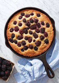 A Summer blackberry buttermilk cake. This simple blackberry cake is baked in a cast-iron skillet, and sports a moist and tender vanilla buttermilk crumb dotted with fresh, sweet blackberries. Easy to make, no electric mixer required, and gluten-free friendly. #summerbaking #fruitdessert | Get the recipe from forkknifeswoon.com!