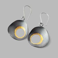 These gorgeous organic dark earrings are full of drama. Handmade from sterling silver and 24k gold finished in a dark patina. Hang from sterling silver ear wires Measures 1 3/4″ long by an inch wide. Arrives in a gift box with a bow.