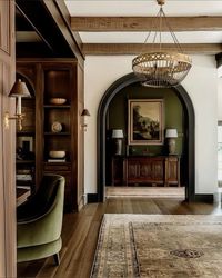 green paint and wood pillars arch doorway in home