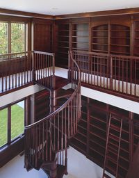 For book lovers, here is upper view of a chestnut colored custom-built library that can make your book collection even more sophisticated with the overall display . #customhomes #library #librarydesign #wood