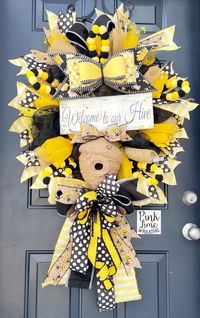 Bee wreath with welcome to our hive sign, bee skep, and beautiful bows! Perfect for a welcoming addition to any door this summer!