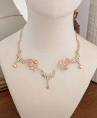 Beautifully Enchanting necklace adorned with whimsical pink roses, gold apples and crystal hearts.  A truly unique piece of jewelry to cherish for years to come.  DETAILS *Handmade in my small boutique studio. *The chain is gold filled. *Necklace measures 16" with 2" extension chain (Please message me if you with for the chain length to be extended or made shorter)  *Your necklace will arrive securely in a necklace jewelry box. Please use this box when not wearing your necklace to avoid it getti