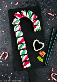 Candy Cane Sushi Rolls - These beautiful uramaki (inside-out) rolls are 100% vegan, and get their colorful stripes from all-natural homemade dyes. Step-by-step video tutorial + tips & tricks will have you rolling out these fun & colorful sushi rolls with ease! Perfect for Christmas bento boxes and holiday party appetizers. | loveatfirstbento.com