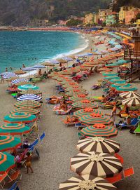 Umbrellas form a curved line on the beach in Monterosso, one of the five towns in Italy's Cinque Terre, Liguria