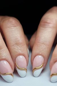 Nails fit for a princess! These stunning almond-shaped nails boast a chic combination of nude, white, and gold. The mesmerizing golden swirl adds a touch of elegance, making these the ultimate wedding manicure. Prepare to sparkle on your special day! // Photo Credit: Instagram @nailnoircheshire