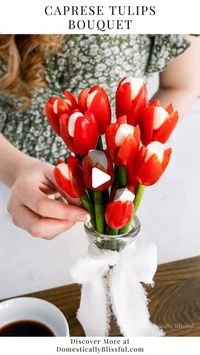 Giustina | DIYs • Recipes • Home Inspiration on Instagram: "Like + Comment “Link” to instantly get the links, tutorial, & details in your DM. 

Years ago (way back in 2018 – can you believe that was 7 years ago!?) I made a Cherry Tomato Tulip Bouquet, filled with a goat cheese/cream cheese herb filling. It was so good!!

I decided to make it again, but a little bit simpler with a mini mozzarella ball in the center this time.

The scallions can be eaten (as I know some people love them as is) or they can be washed and reused to make other recipes!

This is such a fun and easy recipe for a spring party or Easter brunch, and you only need 3 ingredients!

Or you could make it with 4 ingredients and add small basil leaves near the top around the tomato.

I served this Caprese Tulips Bouquet wit