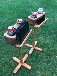 Pair of double drink holders with ledge for phone or digital scoreboards. Great for convenience, but also for use with scoring apps on your phone when playing games such as Molkky, bocce, horseshoes, washers, Cornhole, Ringo, table skittles and other games. The gap where the phone or scoreboard sits is 1 3/8 inches wide. If you do not need a pair, I do have single drink holders with a shelf in my shop.