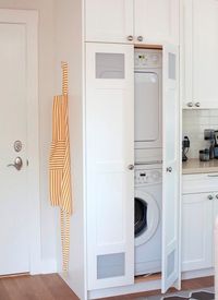 Enclosed washer/dryer and cabinets all around