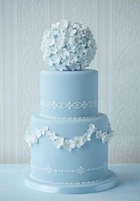 Wedgewood blue wedding cake with sugar flower pomander on top.