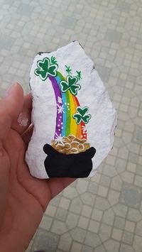 Rainbow with a pot of gold at the end and Shamrocks free hand painted rock