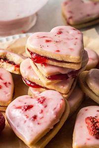 These Heart Shaped Strawberry Shortbread Cookies are perfect for Valentines Day. Buttery, melt in the mouth shortbread cookies are sandwiched together with jam and dipped in a strawberry glaze. Not only do these look gorgeous, you’ll fall in love with the sweet strawberry flavour alongside the shortbread. By Emma Duckworth Bakes