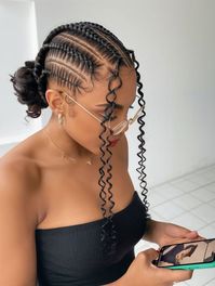 A stunning combination of sleek cornrow braids and a low bun with soft curls, this hairstyle is the epitome of refined elegance. The face-framing curly tendrils add a romantic touch, balancing the structured braids with a hint of playfulness. Whether for a formal event or an everyday sophisticated look, this style ensures versatility and chicness.