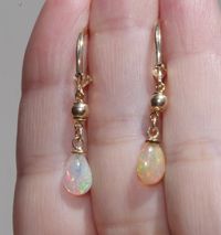 14k gold fiery ethiopian opal elongated lever back earrings ccc fiery ethiopian opal drop lever backs a quality ethiopian opal 7.5 ctw total length of tear drops including bail on avarage: 11- 12mm diameter of round gold balls: 4 mm from top to bottom 35 mm diameter of opals: 7 x12 mm in widest area nice size opal drops