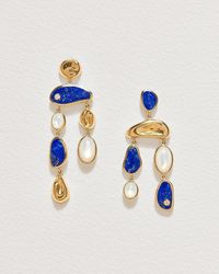 A pair of elegant asymmetrical chandelier earrings. featuring irregular sculptural bezels with lapis and mother of pearl inlay with white corundum.    *this piece is made of recycled and recyclable materials. all of our precious stones are ethically sourced and conflict-free.    details & size    - composition: 14k yellow gold plate over brass lapis mother of pearl white corundum sterling silver ear posts  - measurements: length of side a: 75mm length of side b: 65mm