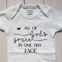 New White Shortsleeve Onesie With Saying "All Of God's Grace In One Tiny Face" Available In Different Colors And All Sizes Please Pm Me For Anything Other Than Nb & Black Text.