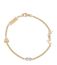 Find SAINT LAURENT Logo Charm Bracelet on Editorialist. A piece of jewellery from Saint Laurent is a surefire way to imbue any after-dark ensemble with an air of evergreen elegance: look to this chain bracelet as a case in point. Consisting of a ysl logo, a sparkling crystal and a heart charm, it's an accessory that one can't help but fall in love with.