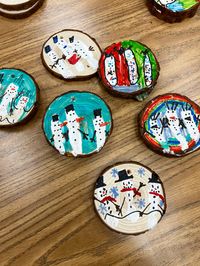 Here are a few of the ornaments my class is working on. I love how each one is decorated differently. Check out my other pins. #snowman #snowmen #ornaments #woodornament #snowmanornament #christmas #diy #schoolcraft #craftingwithkids