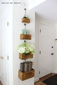 Nesting herb crates hung in kitchen eat-in area hold tabletop necessities (placemats, napkins, salt & pepper)