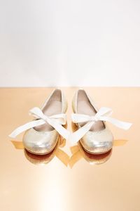 Uniquely elegant golden leather ballerinas with bows. Composition: 100 % genuine leather Lining: 100 % genuine leather Sole: 100 % genuine leather *When selecting Bespoke or MTM service, any style of shoes can be made in a color and material of your choice.